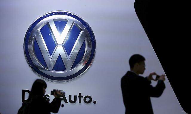File picture of guests standing next to a Volkswagen logo at the stage of the company at the 16th Shanghai International Automobile Industry Exhibition in Shanghai