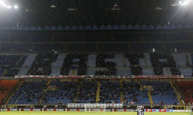 AC Milan's supporters seat on tribune to draw word Basta, before Italian Serie A soccer match against Genoa 