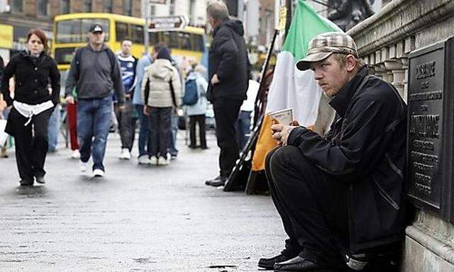 A beggar sits on OConnell Bridge in the centre of DublinConnell Bridge in the centre of Dublin