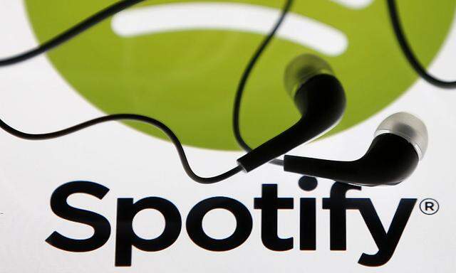 Earphones are seen on a tablet screen with a Spotify logo on it, in Zenica