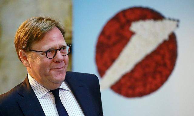 UniCredit unit Bank Austria Chief Executive Cernko passes a company logo before a news conference in Vienna