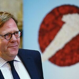 UniCredit unit Bank Austria Chief Executive Cernko passes a company logo before a news conference in Vienna