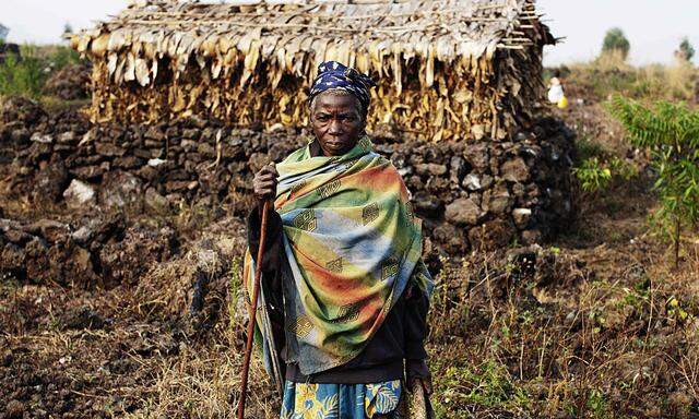 A member of a pygmy community pauses for a portrait on her way to the fields in eastern Congo