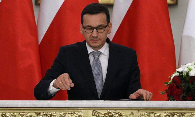 Newly appointed Polish Prime Minister Morawiecki reacts after receiving his nomination from President Duda during a government swearing-in ceremony in Warsaw