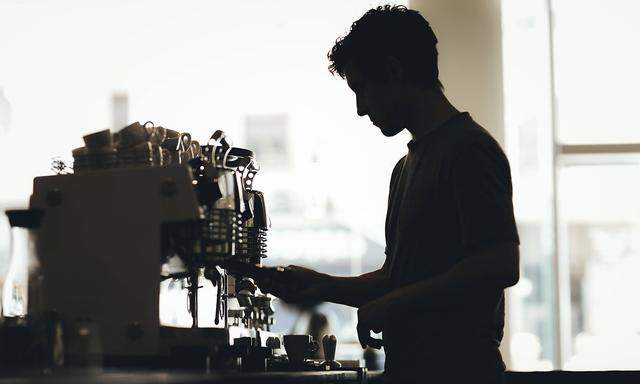 Silhouette of Barista preparing coffee in a coffee bar model released Symbolfoto property released