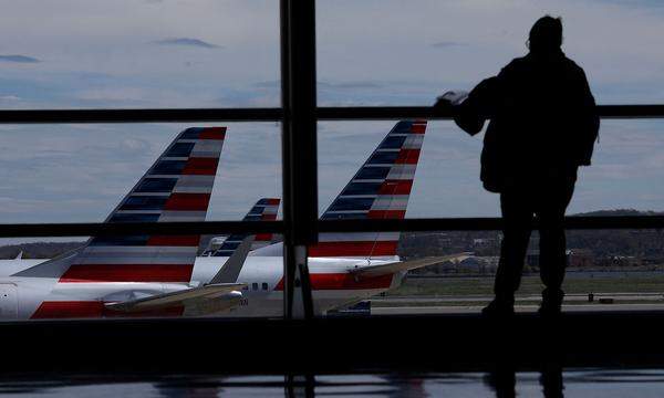 FILE PHOTO: American Airlines aircraft are seen while a passenger waits for boarding at the Reagan International Airport in Washington