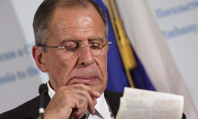 Russia's FM Lavrov reads notes during a news conference in Washington