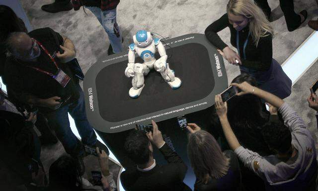 People take pictures of robot Watson at the IBM stand during the Mobile World Congress MWC in Barc