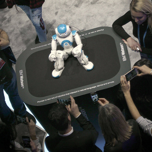 People take pictures of robot Watson at the IBM stand during the Mobile World Congress MWC in Barc