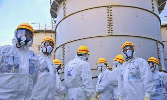 Team of IAEA experts check out water storage tanks at TEPCO's Fukushima Daiichi Nuclear Power Station