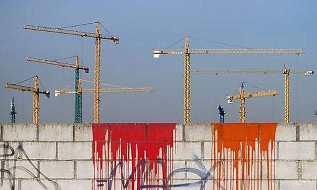 Cranes are seen on an unfinished construction site on the outskirts of Madrid Thursday Nov. 25, 2010.