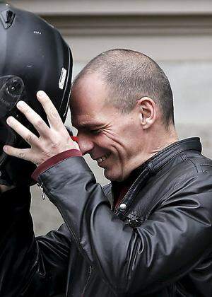 File photo of Greek Finance Minister Varoufakis wearing his helmet before leaving the Maximos Mansion on his motorbike after a meeting with PM Tsipras in Athens