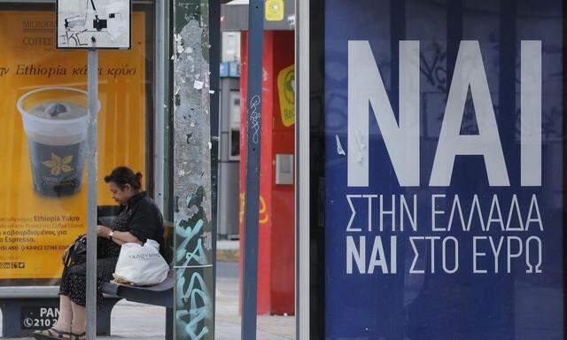 A poster that reads  'Yes, to Greece, Yes to the Euro' is seen on a bus stop in Athens