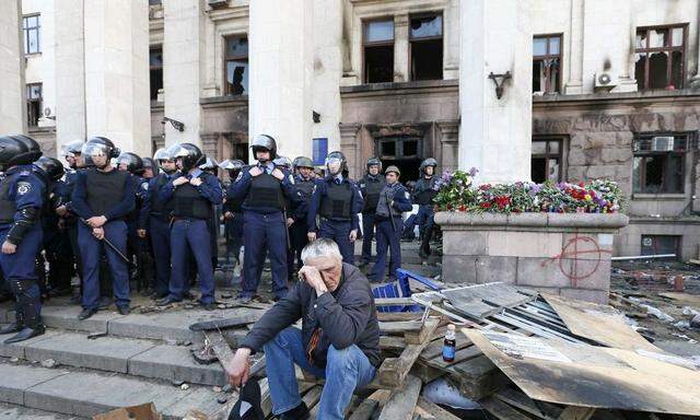 A man reacts outside trade union building, where deadly fire occurred, in Odessa