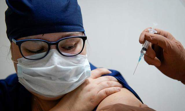 FILE PHOTO: FILE PHOTO: A medic of the regional hospital receives  Russia's 'Sputnik-V' vaccine shot against the coronavirus disease (COVID-19) in Tver