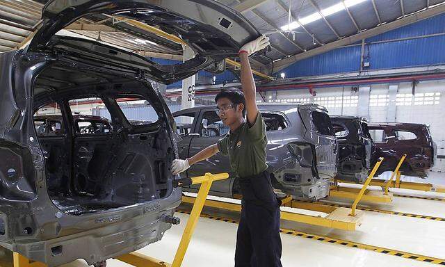 File photo of an employee working on a Chevrolet Spin MPV at a General Motors plant in Bekasi, outskirt of Jakarta