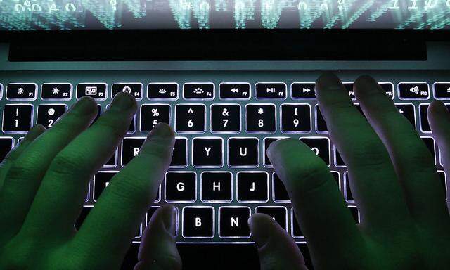 Illustration file picture shows a man typing on a computer keyboard in Warsaw