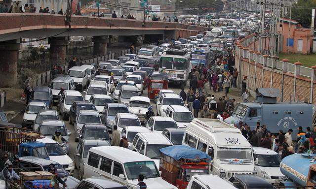 Vehicles jam the road after a flyover was briefly closed to vehicular traffic for precautionary measures following an earthquake in Srinagar