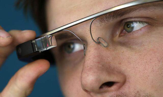 A man adjusts his Google glasses after a media presentation of a Google apartment in Prague