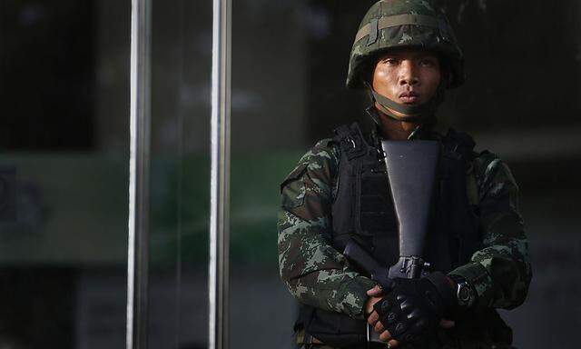 A Thai soldier stands in front of the Army Club in Bangkok