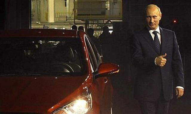 Russias PM Putin stands next to the new Hyundai Solaris car during the opening ceremony of a Hyundais PM Putin stands next to the new Hyundai Solaris car during the opening ceremony of a Hyundai