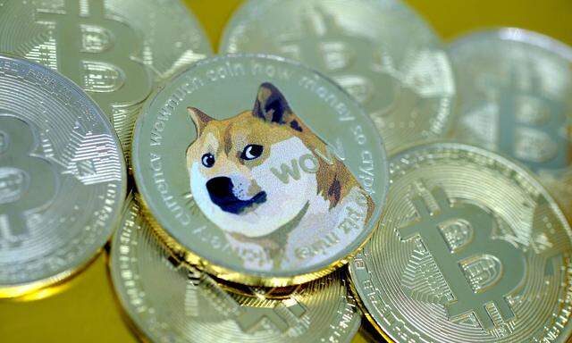 In this photo illustration, visual representations of digital cryptocurrencies, Dogecoin and Bitcoin, are arranged on J