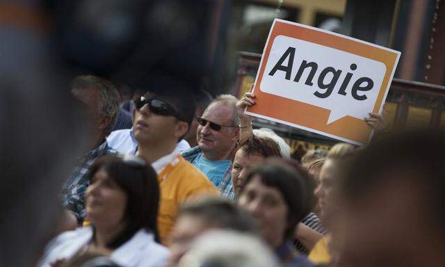 People listen to German Chancellor CDU head Merkel at CDU election campaign event in Wernigerode