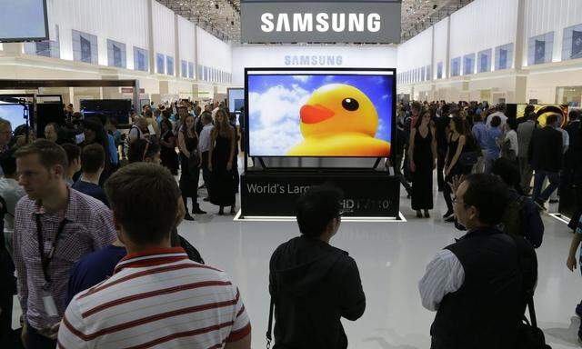 Visitors look at latest Samsung products during opening day of IFA consumer electronics fair in Berlin