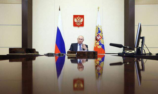 Russian President Vladimir Putin chairs a meeting with members of the government via video link at a residence outside Moscow