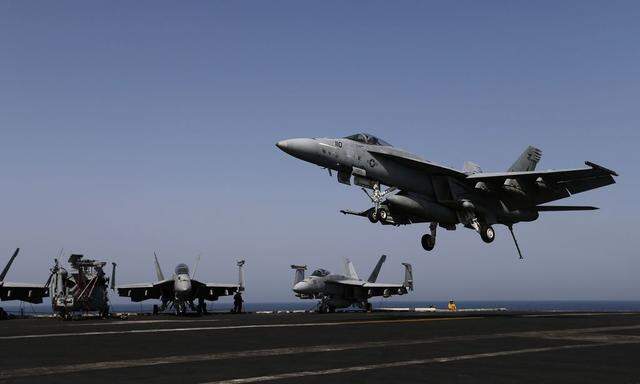 A F/A-18E comes in to land onboard USS George H.W. Bush in the Gulf