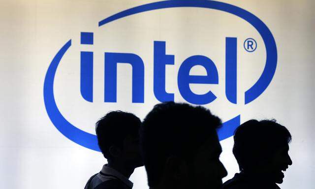 Indonesian youth walk past an Intel sign during Digital Imaging expo in Jakarta in this file photo