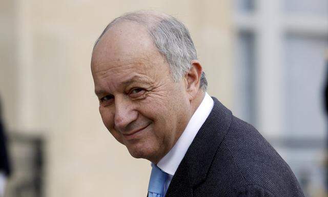 French Foreign Affairs Minister Laurent Fabius arrives at the Elysee Palace in Paris