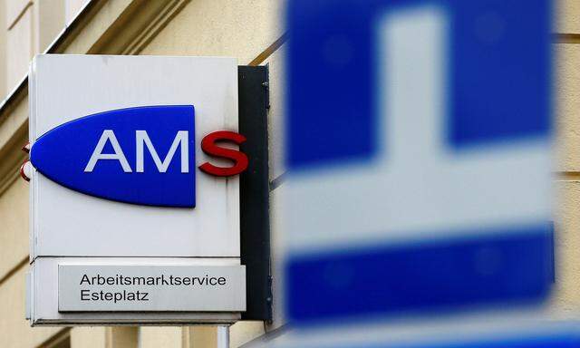 The logo of AMS jobcentre is seen behind traffic signs in Vienna