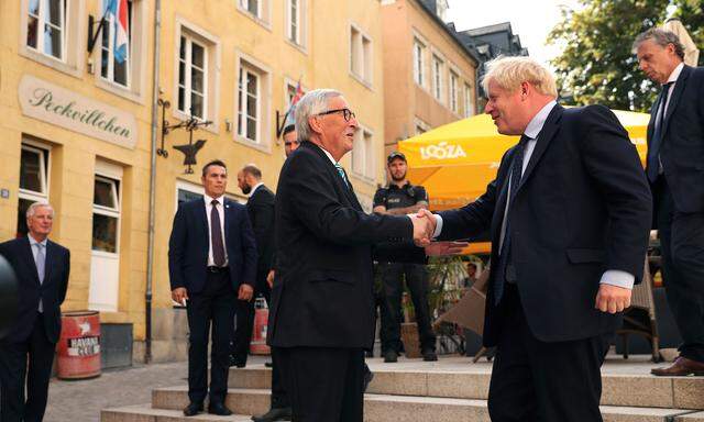 EC President Juncker shakes hands with British PM Johnson in Luxembourg