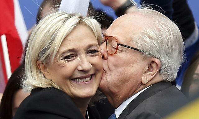 File photo of Jean-Marie Le Pen, France's National Front political party founder, and his daughter Marine Le Pen, National Front political party leader, after her speech at their traditional rally in Paris