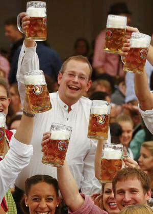 FILE PHOTO: A waiter carries glasses of beer during the opening day of Oktoberfest in Munich