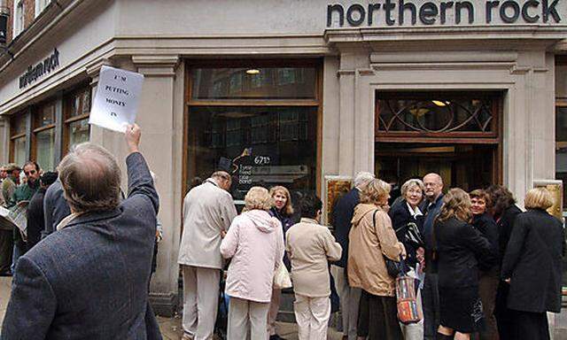 Customers queuing outside a  branch of the British  mortgage lender Northern Rock in York England , a