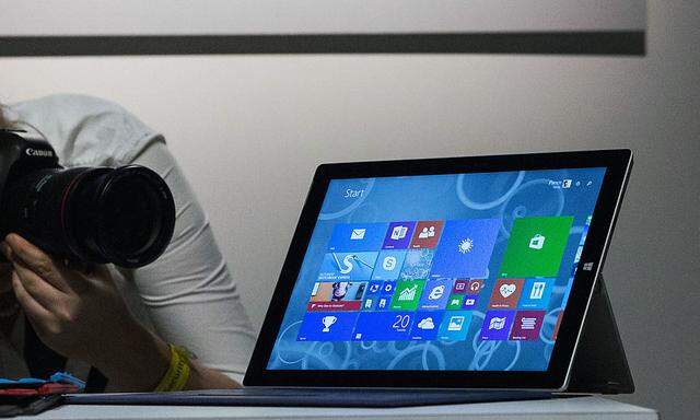 An attendee photographs the new Microsoft Surface Pro 3, during the event in New York