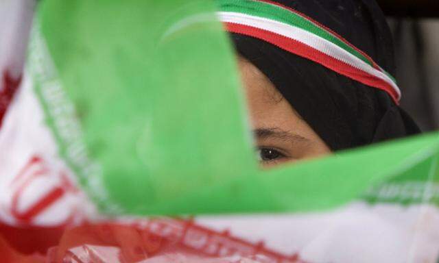 Girl waves an Iranian flag during a victory ceremony for President Mahmoud Ahmadinejad in central Tehran