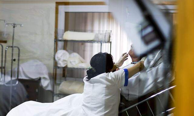 A nurse takes care of a coma patient at Sant´Anna hospital in Crotone