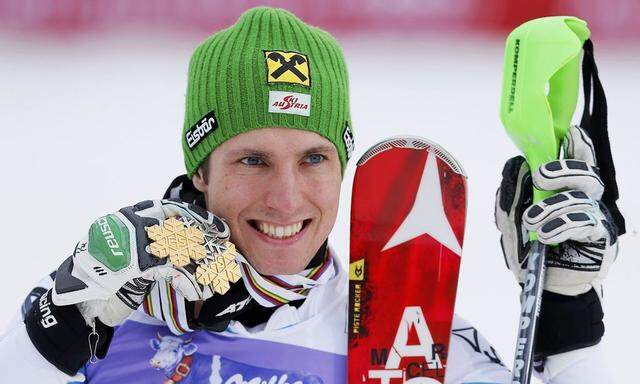 Marcel Hirscher of Austria shows off his medals, gold for team event and slalom with a silver for the giant slalom, during the medal ceremony of the men's Slalom race at the World Alpine Skiing Championships in Schladming 