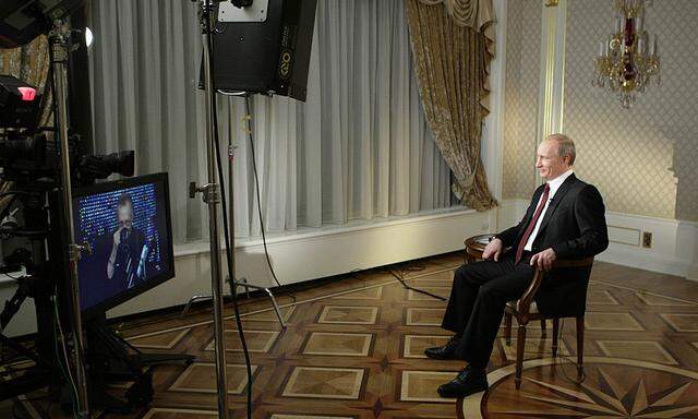 Russia´s Prime Minister Putin smiles during an interview with Larry King in Moscow