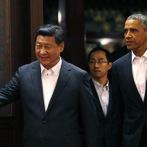 China´s President Xi gestures to U.S. President Obama as they enter a room before a meeting at the Zhongnanhai leadership compound in Beijing