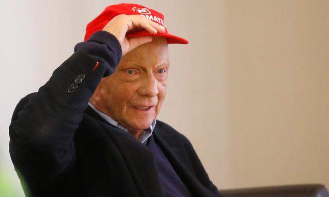 Former motor racing champion Niki Lauda adjusts his hat during a meeting with Niki's employees at Vienna airport in Schwechat