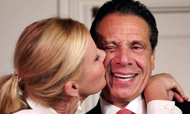 New York Governor Andrew Cuomo is kissed by his girlfriend Sandra Lee after voting in the New York Democratic primary election at the Presbyterian Church in Mt. Cisco