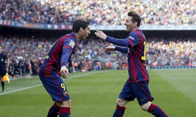Barcelona's Messi and Suarez celebrate a goal against Valencia during their Spanish first division soccer match at Camp Nou stadium in Barcelona