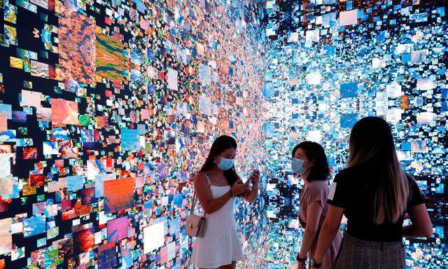 FILE PHOTO: Visitors are pictured in front of an art installation which will be converted into NFT and auctioned online at Sotheby's, in Hong Kong