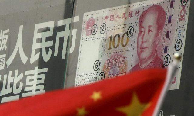File photo of a Chinese national flag in front of a poster explaining the design of new 100 yuan banknote at a branch of a commercial bank in a business district in Beijing