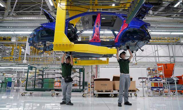 FILE PHOTO: Employees work at the production line inside the Chery Jaguar Land Rover plant phase 2 after the phase 2 opening ceremony in Changshu