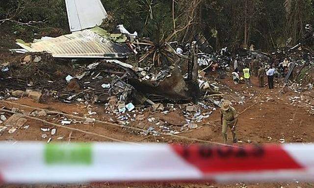 Officials investigate the scene of Saturdays fatal plane crash of Air India Express in Mangalore, ins fatal plane crash of Air India Express in Mangalore, in